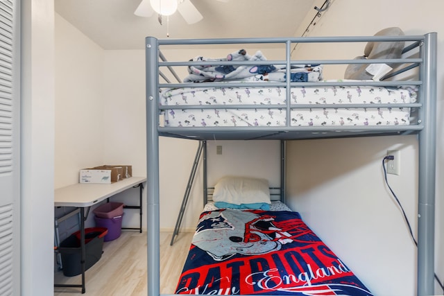 bedroom with light hardwood / wood-style flooring and ceiling fan