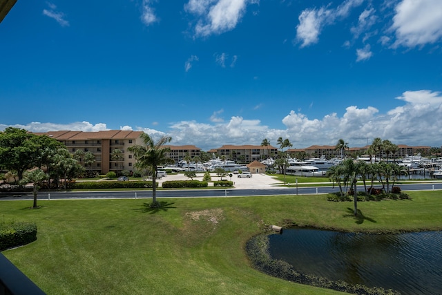 view of community with a water view and a yard