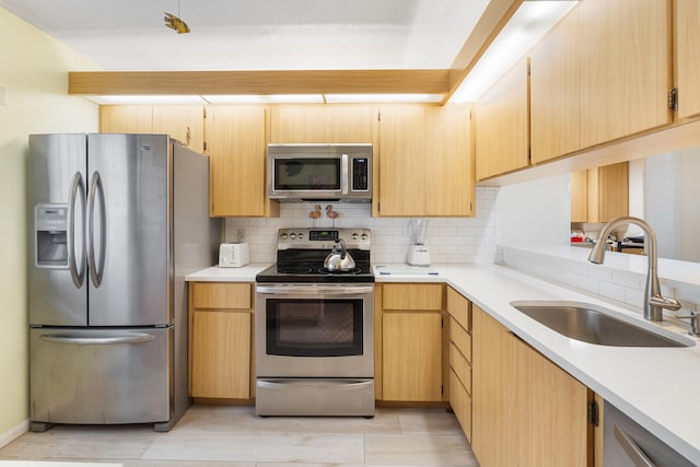 kitchen featuring sink, appliances with stainless steel finishes, backsplash, and light brown cabinets