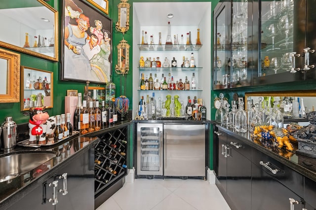 bar featuring sink, light tile patterned floors, and fridge