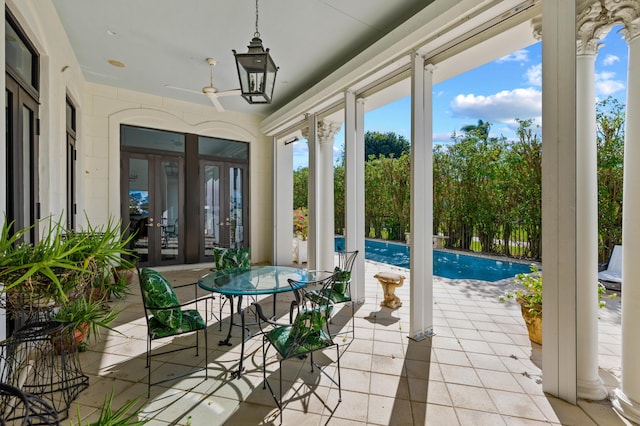 sunroom featuring ceiling fan and french doors