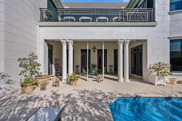 back of house with a balcony and a patio area