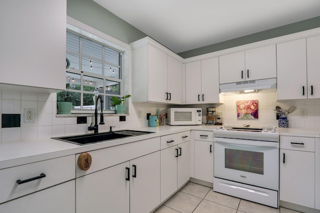 kitchen with white cabinetry, white appliances, sink, and tasteful backsplash