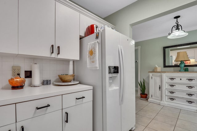 kitchen with backsplash, white cabinetry, white fridge with ice dispenser, and pendant lighting