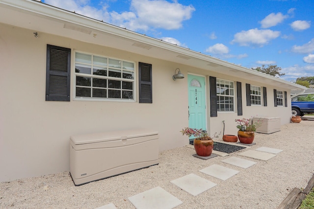 entrance to property featuring stucco siding