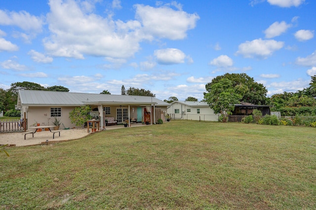 back of house featuring a patio area and a yard