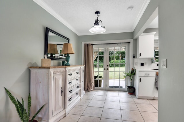 doorway to outside with crown molding, french doors, light tile patterned floors, and a textured ceiling