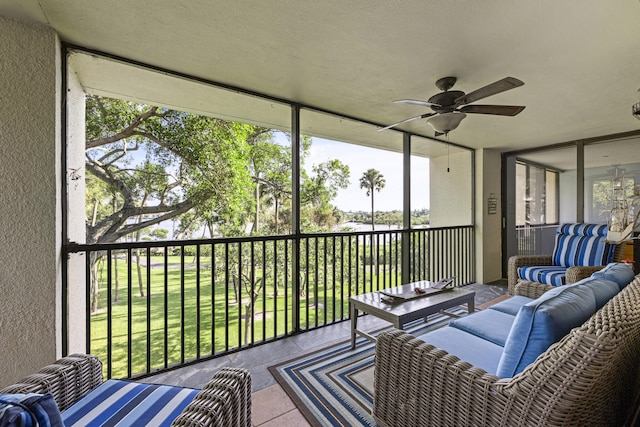 sunroom featuring ceiling fan