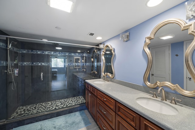 bathroom with tile patterned floors, vanity, and an enclosed shower