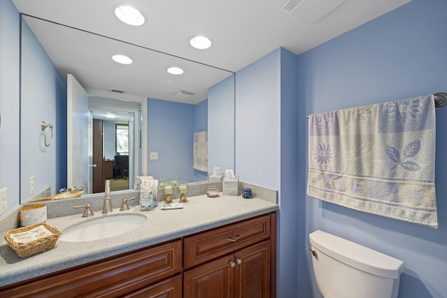 bathroom featuring vanity and toilet