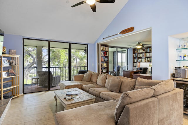 living room with a wealth of natural light, light hardwood / wood-style flooring, ceiling fan, and beverage cooler