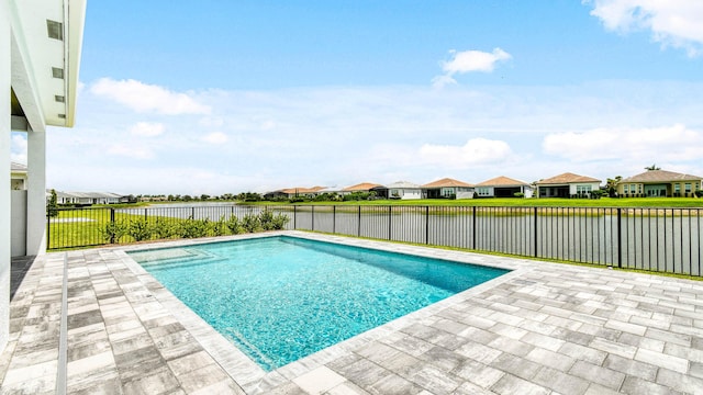 view of swimming pool featuring a water view and a patio