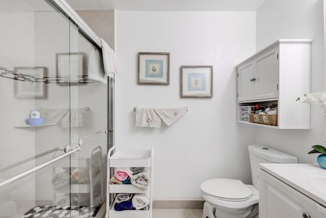 bathroom with vanity, walk in shower, tile patterned flooring, and toilet