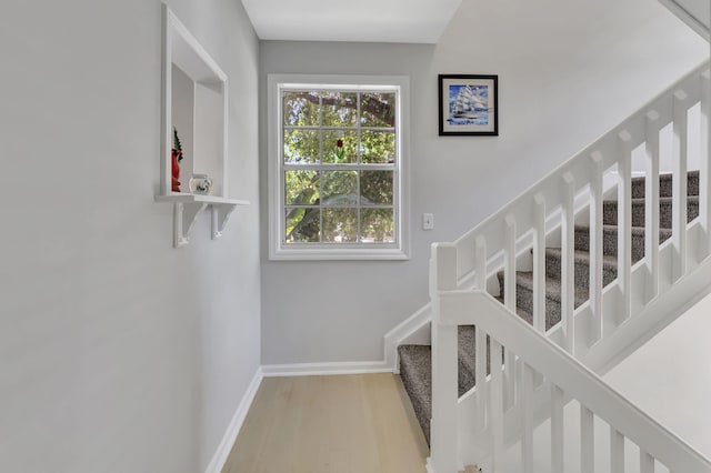 stairs featuring light hardwood / wood-style floors