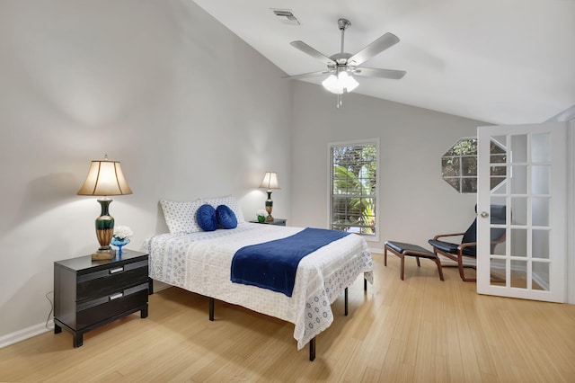 bedroom with ceiling fan, light hardwood / wood-style flooring, and vaulted ceiling