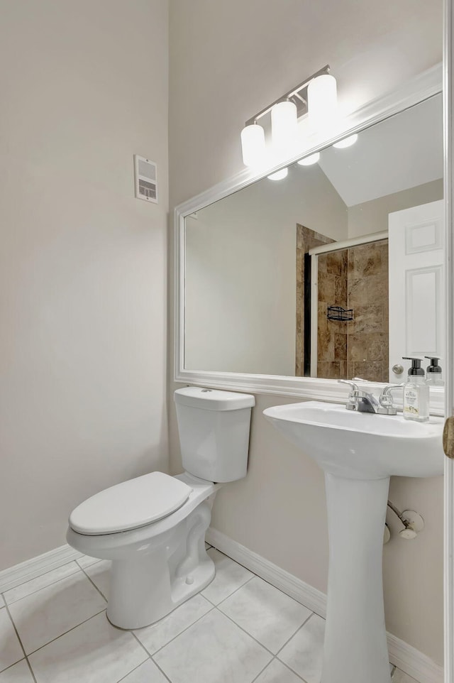 bathroom with tile patterned flooring and toilet