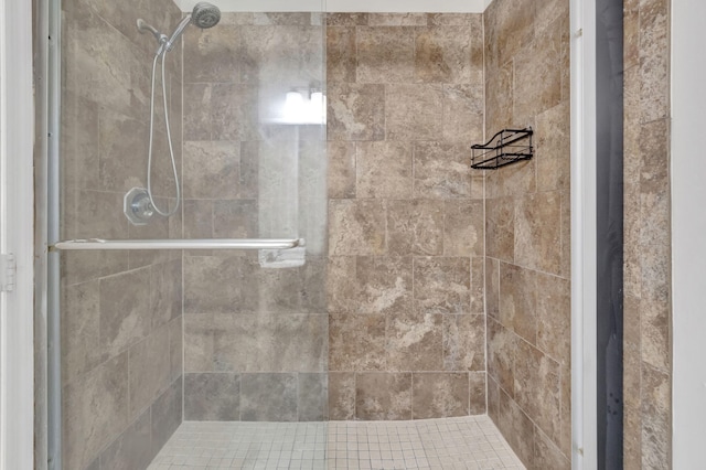 bathroom with a tile shower