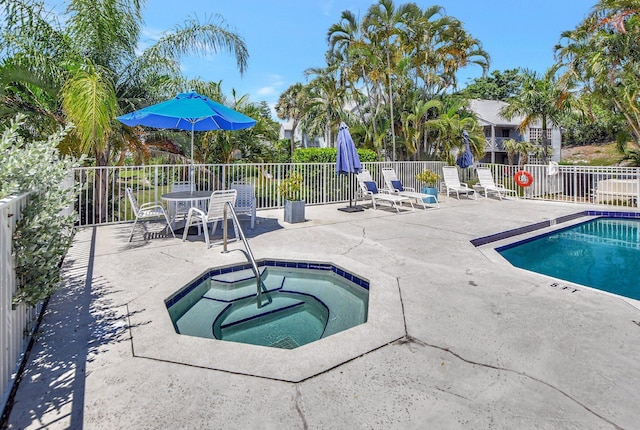 view of swimming pool with a community hot tub and a patio