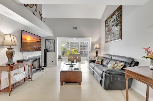 living room with high vaulted ceiling