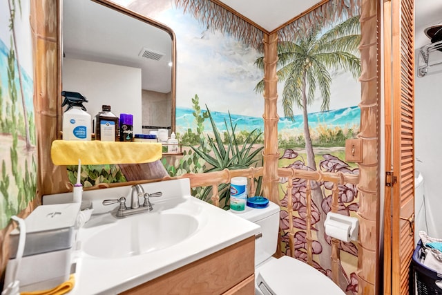 bathroom with toilet and vanity