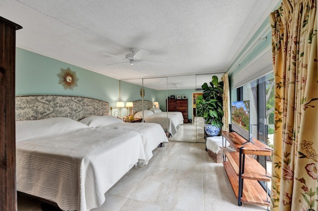 bedroom with a textured ceiling and ceiling fan