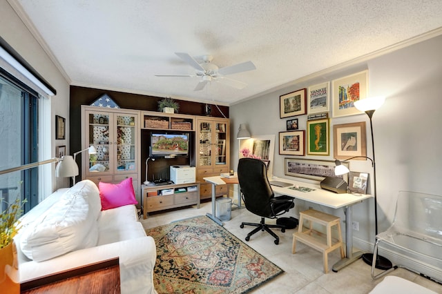 tiled home office with ceiling fan, crown molding, and a textured ceiling