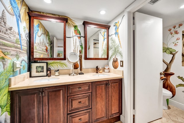 bathroom featuring toilet and vanity