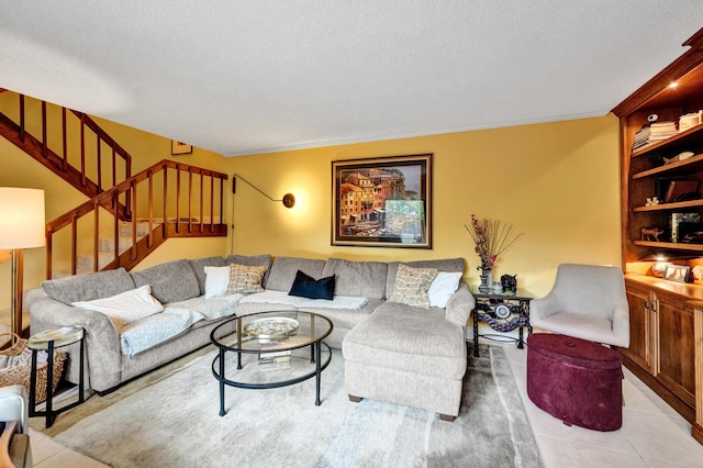 living room featuring a textured ceiling and light tile patterned floors