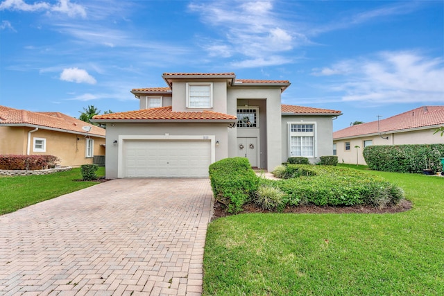 mediterranean / spanish house featuring a front yard and a garage