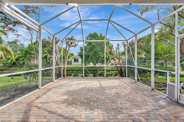 unfurnished sunroom with a water view