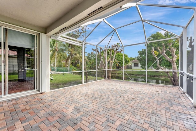 unfurnished sunroom with a water view