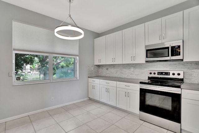 kitchen featuring hanging light fixtures, tasteful backsplash, appliances with stainless steel finishes, and white cabinets