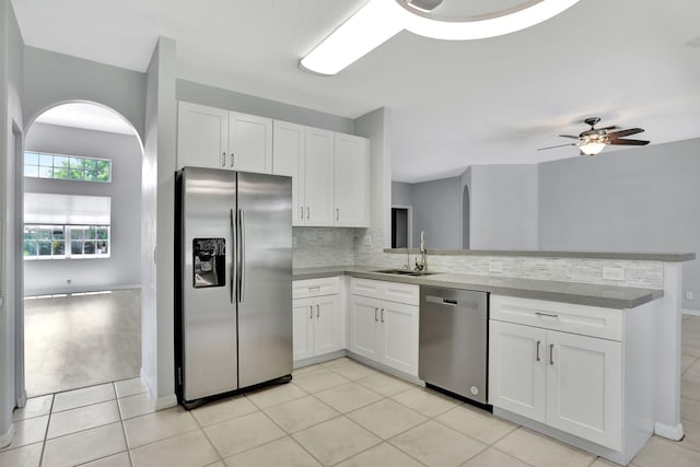 kitchen with white cabinetry, ceiling fan, stainless steel appliances, and sink