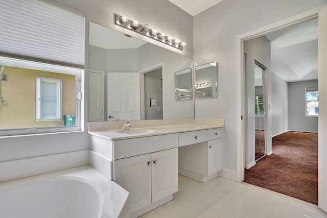 bathroom with vanity and a washtub