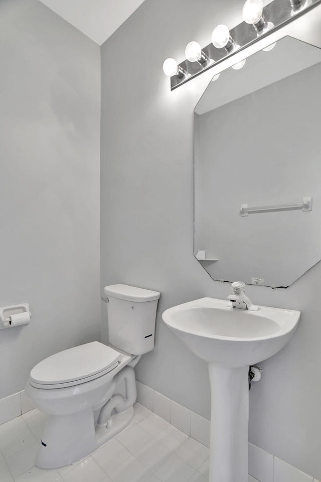 bathroom with toilet and tile patterned floors