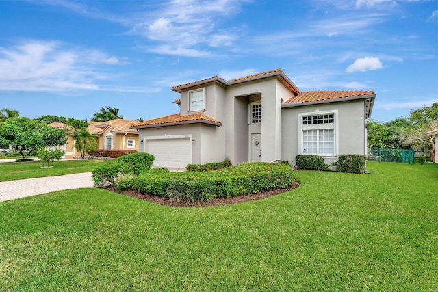 mediterranean / spanish-style home featuring a front yard