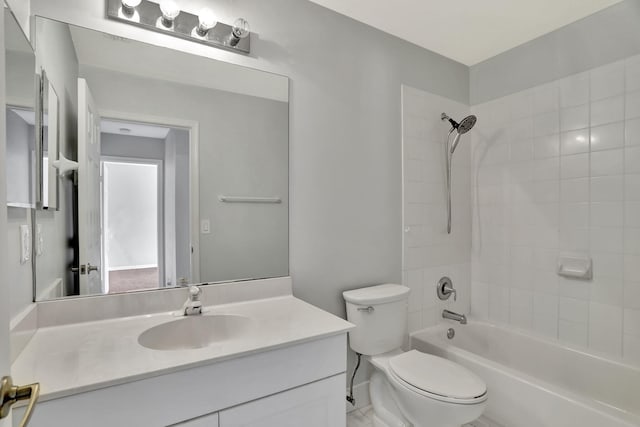 full bathroom featuring toilet, tiled shower / bath, and vanity