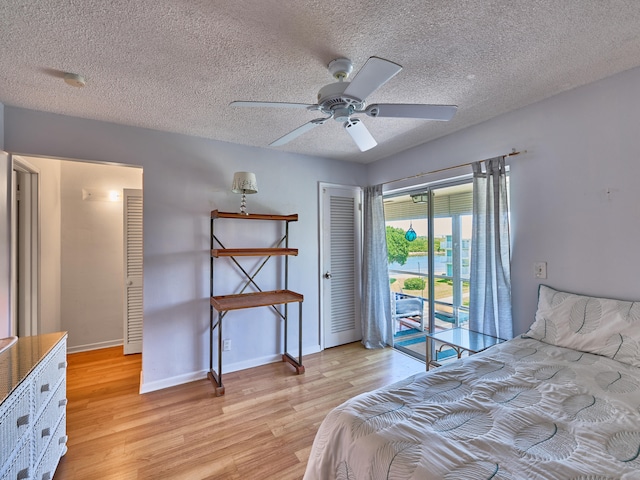 bedroom with light hardwood / wood-style flooring, a closet, access to exterior, a textured ceiling, and ceiling fan