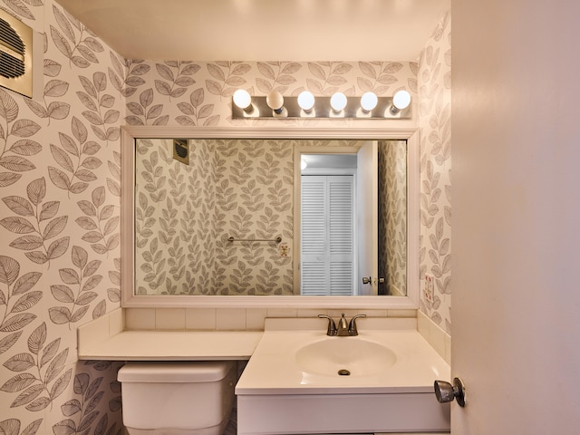 bathroom with toilet and vanity