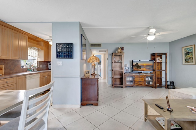 kitchen featuring light brown cabinets, dishwasher, ceiling fan, tasteful backsplash, and light tile patterned flooring