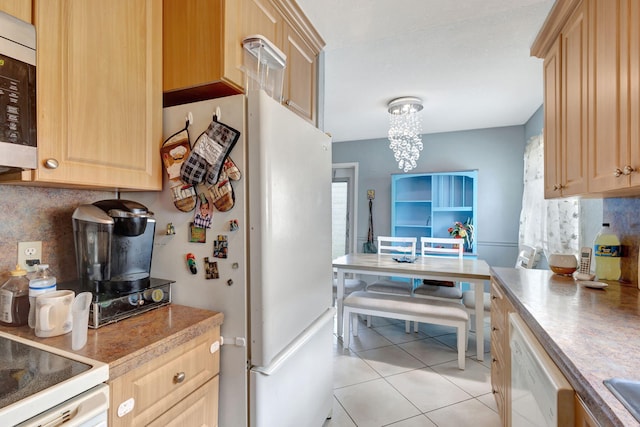 kitchen with light brown cabinetry, tasteful backsplash, light tile patterned floors, white appliances, and a chandelier