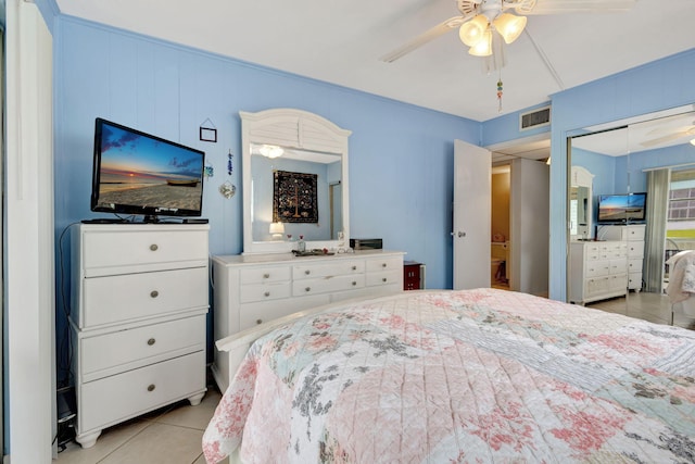 bedroom featuring ceiling fan, a closet, and light tile patterned flooring