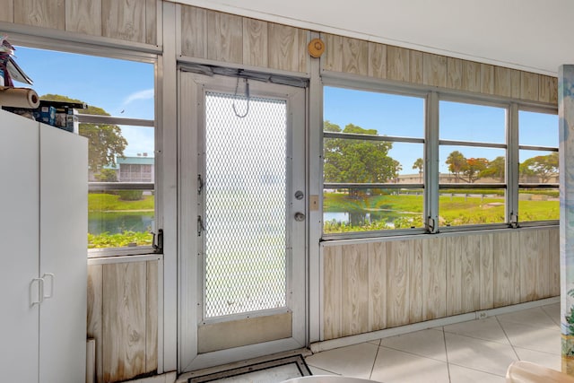 doorway to outside featuring wooden walls and a water view