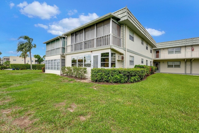 rear view of property with a yard