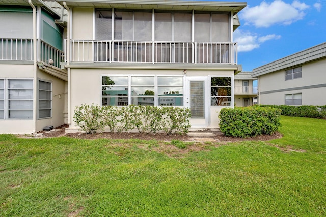 rear view of property with a yard