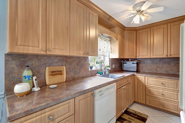 kitchen with dishwasher, tasteful backsplash, sink, ceiling fan, and light tile patterned floors