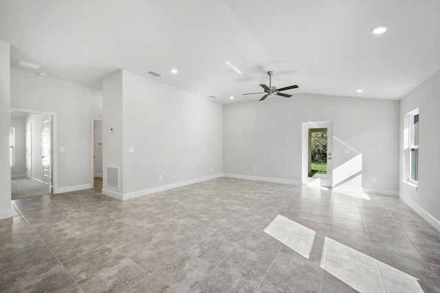 unfurnished living room with ceiling fan, light tile patterned floors, and vaulted ceiling