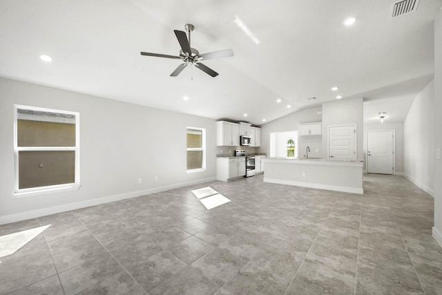 unfurnished living room featuring ceiling fan, sink, light tile patterned flooring, and lofted ceiling