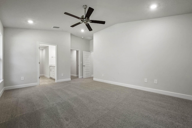 unfurnished bedroom with carpet flooring, ensuite bathroom, vaulted ceiling, and ceiling fan