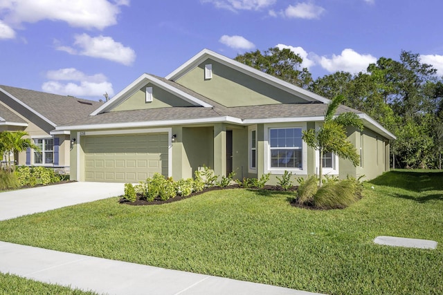 view of front of home with a garage and a front lawn